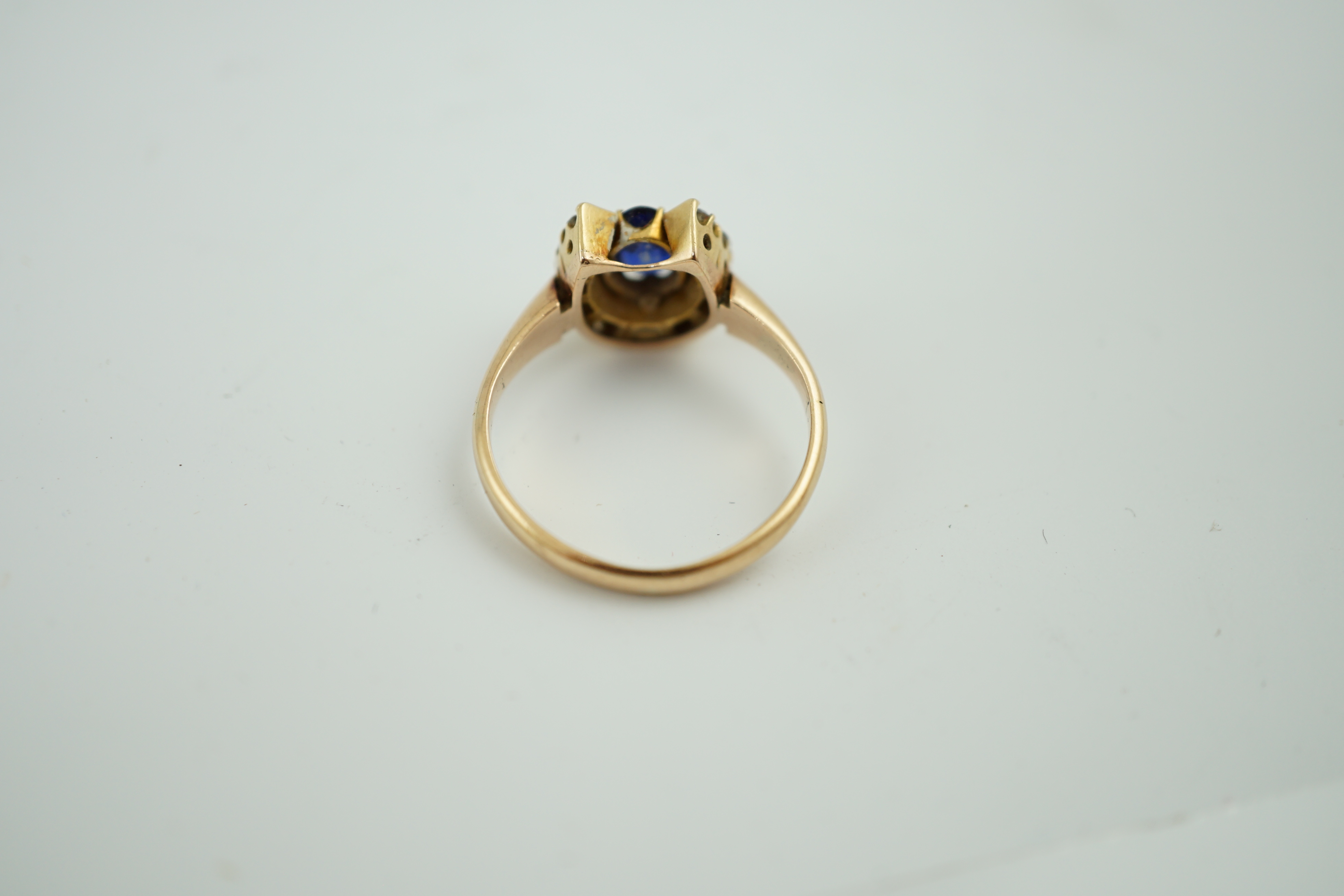 An early to mid 20th century gold, sapphire and diamond set horseshoe cluster ring